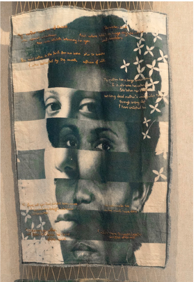 Kathleen McDonald, "Thread My Mother Gave Me," 2017 A fabric pendant with black and white femme eyes, noses and mouths in a horizontal pattern. The cloth is embroidered with text.