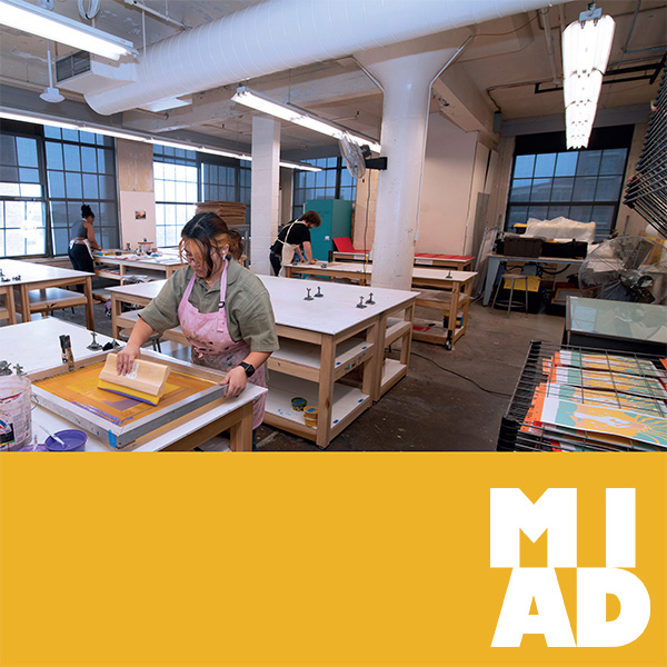 InfoDay_Generic A student works in the printmaking lab making a screen print.