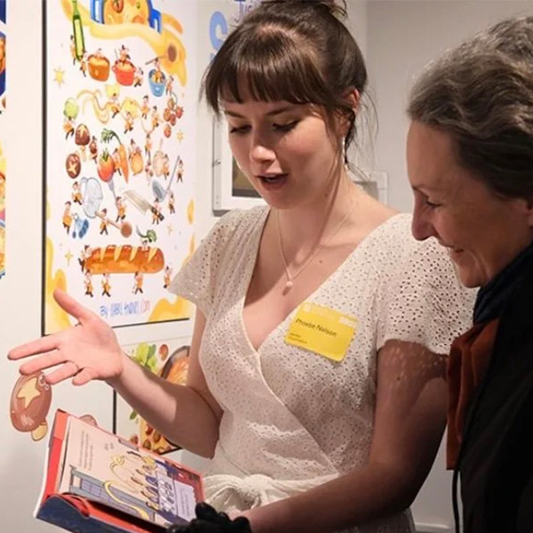AlumniSeniorThesisAwards_PhoebeNelson Phoebe Nelson shows a visiter her senior exhibition project.