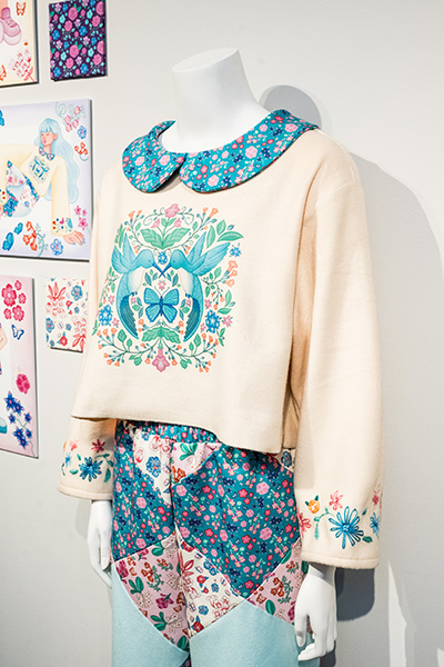 A patchwork shirt and pants with patterned, detailed fabric.