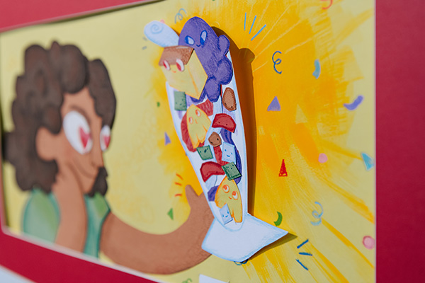 A page of a book with a person looking at a 3D papercut illustration of halo-halo.