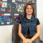 Julianna Frixione sits in the chair she designed in front of her mood board.