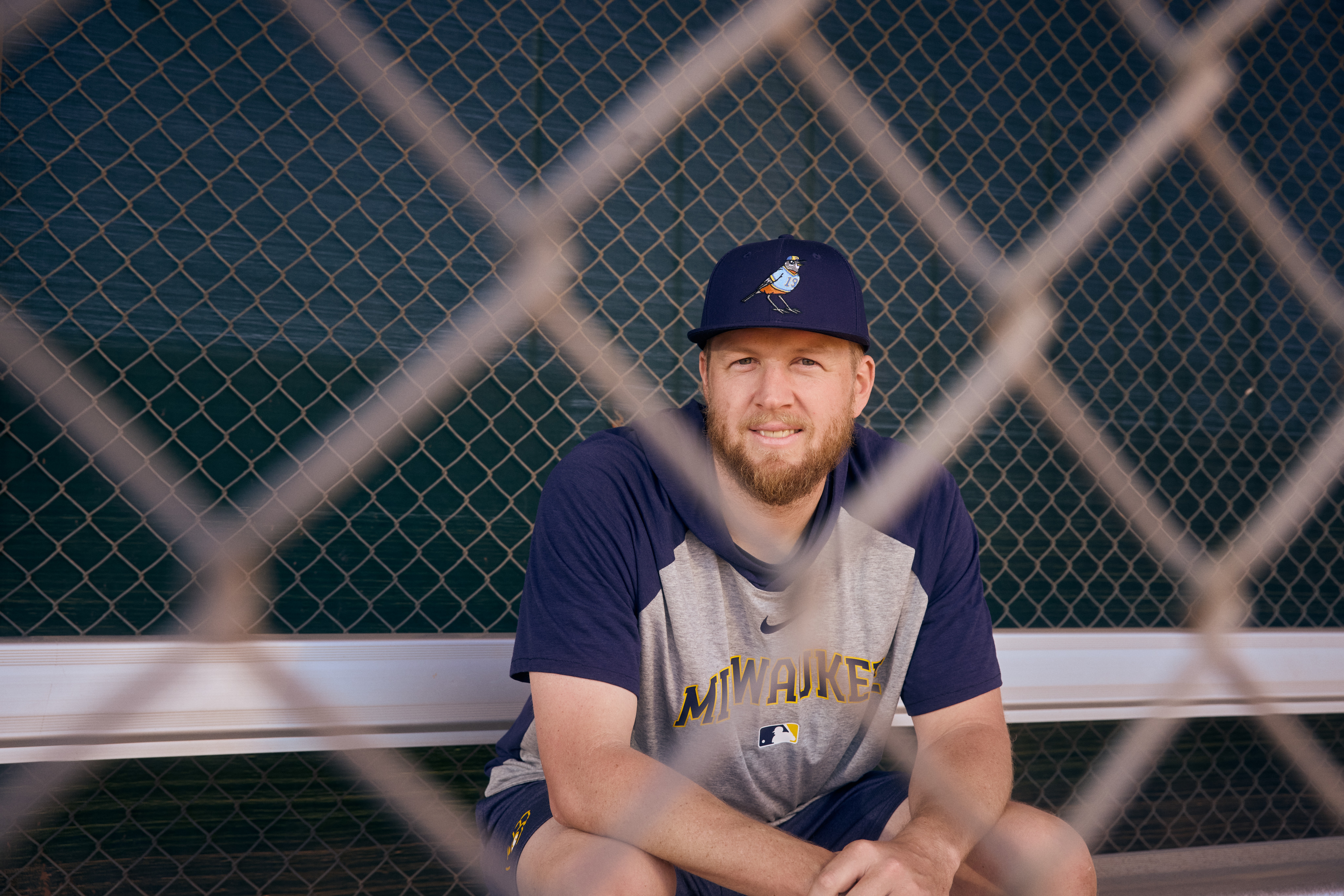 Brewers Pitcher Jared Koenig sits behind a fence