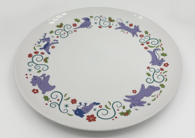 Illustrated plate design featuring winter animals