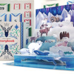 A pop up advent calendar featuring arctic animals in shades of blue and purple