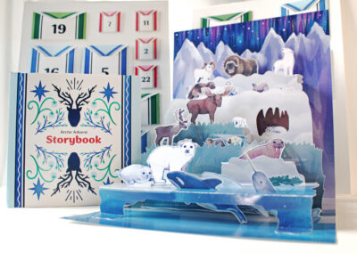 A pop up advent calendar featuring arctic animals in shades of blue and purple
