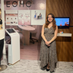 Carmen Briones ‘26 (Product Design) standing in her "Echo" exhibit featuring her wearable ultrasound device.