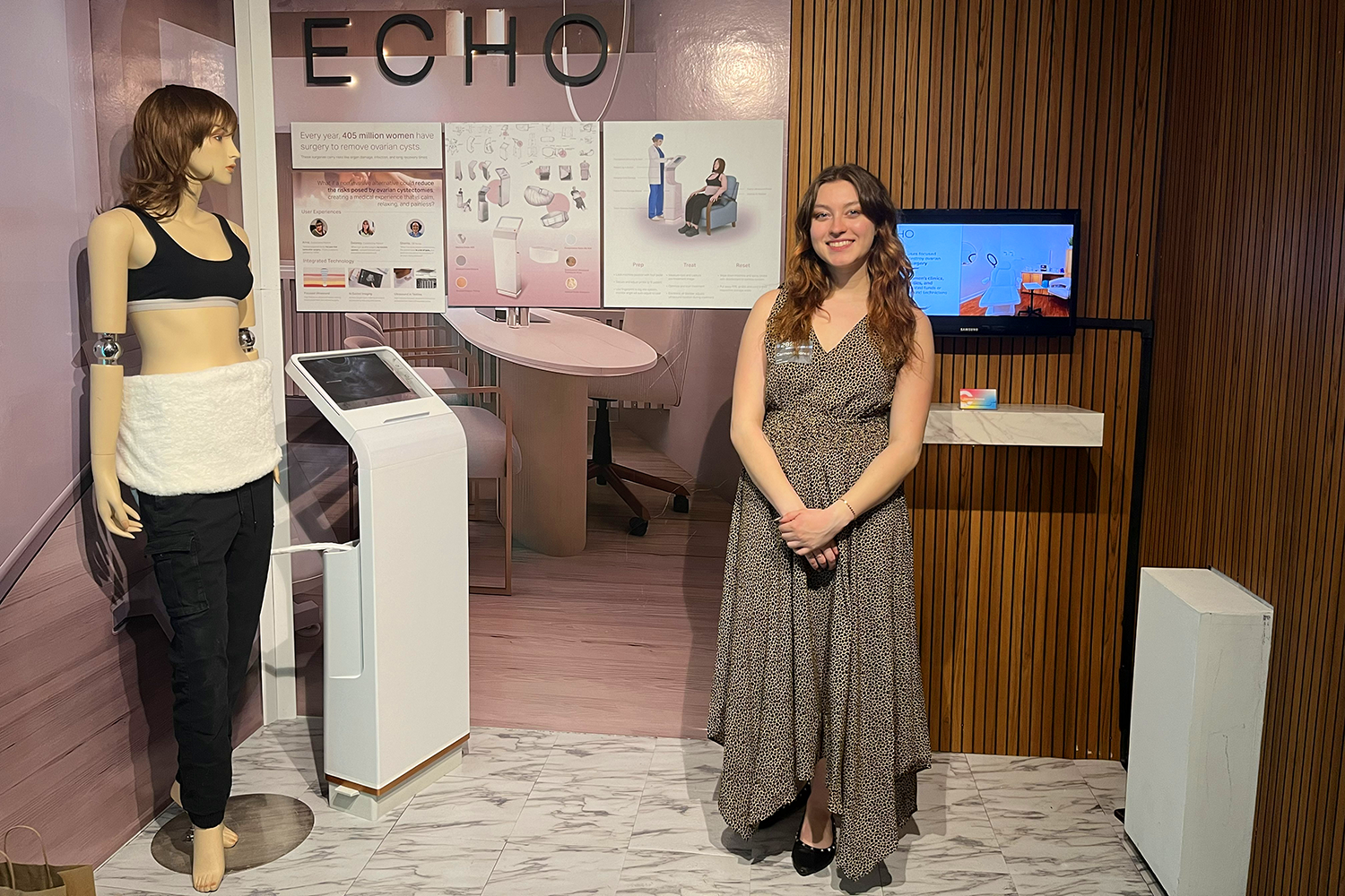 Carmen Briones ‘26 (Product Design) standing in her "Echo" exhibit featuring her wearable ultrasound device.