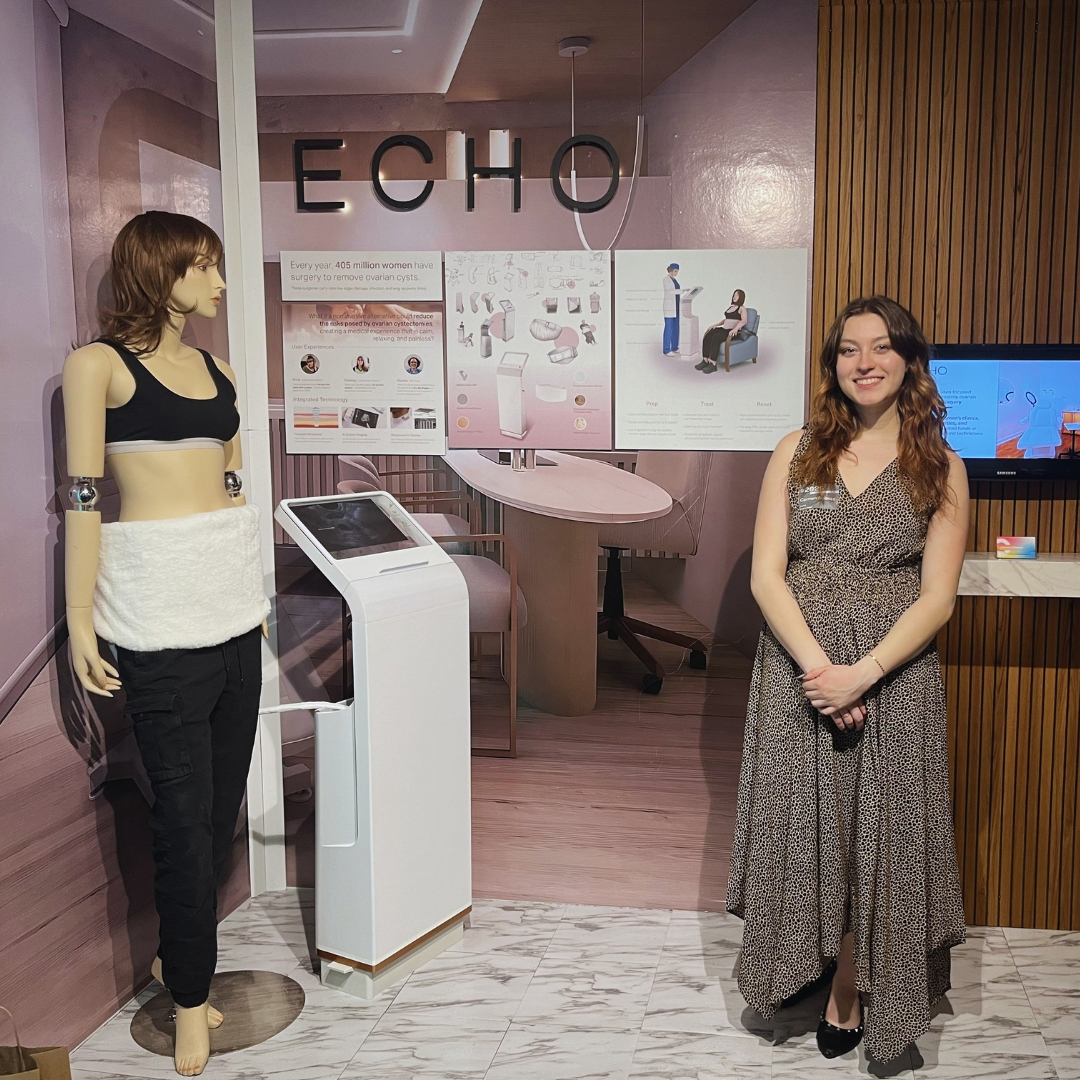 Carmen Briones ‘26 (Product Design) standing in her "Echo" exhibit featuring her wearable ultrasound device.