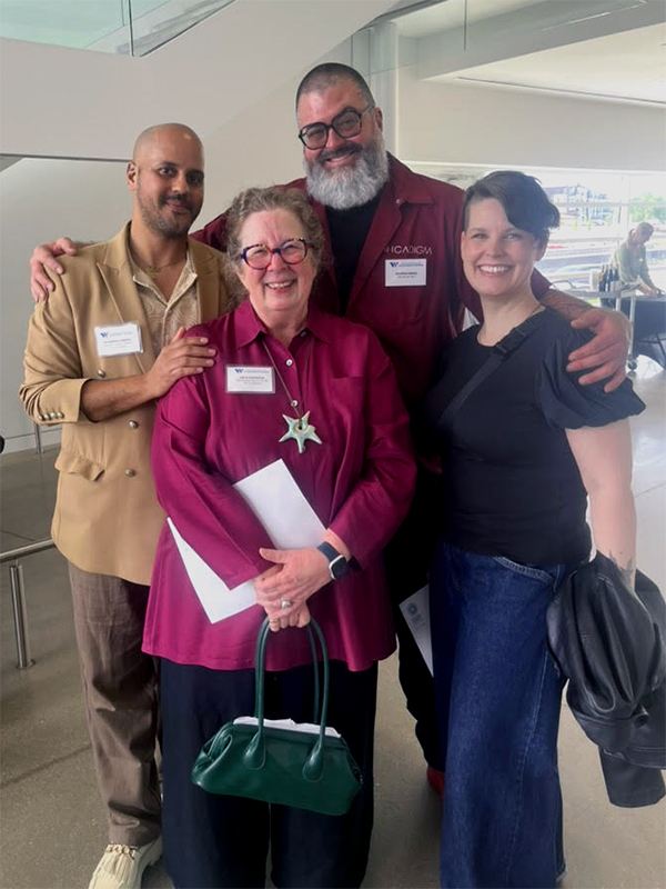 Leslie Fedorchuk, CK Ledsema, Brandon and Angela Minga stand together smiling inside a building, two with arms around the group; one holds a small green handbag and a folded program.
