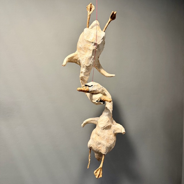 Sculpted ducks hanging from a string